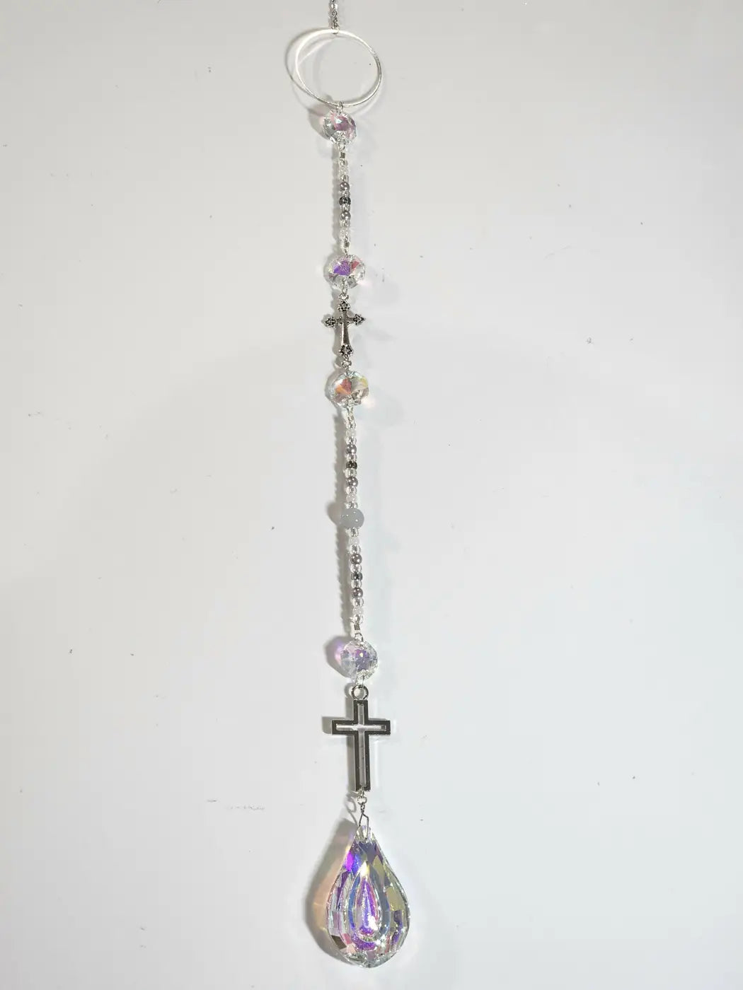 Long suncatcher with silver-toned rosary design, iridescent crystal beads, and teardrop prism for direct sunlight display