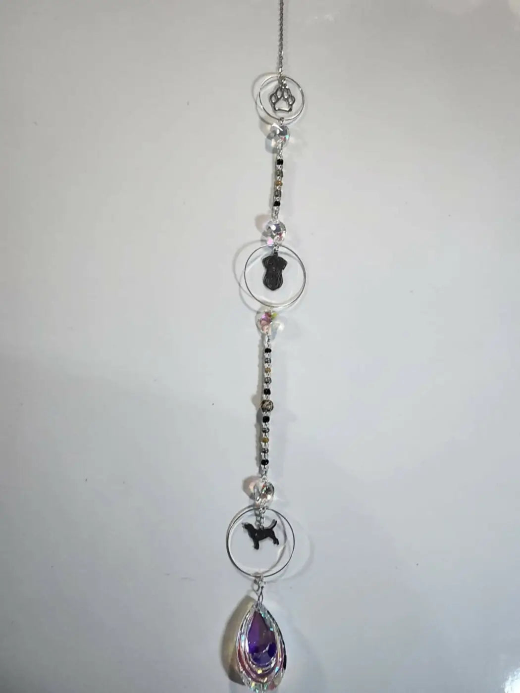 Silver chain long suncatcher with circular frames, black dog silhouettes, and clear purple crystal accents for direct sunlight
