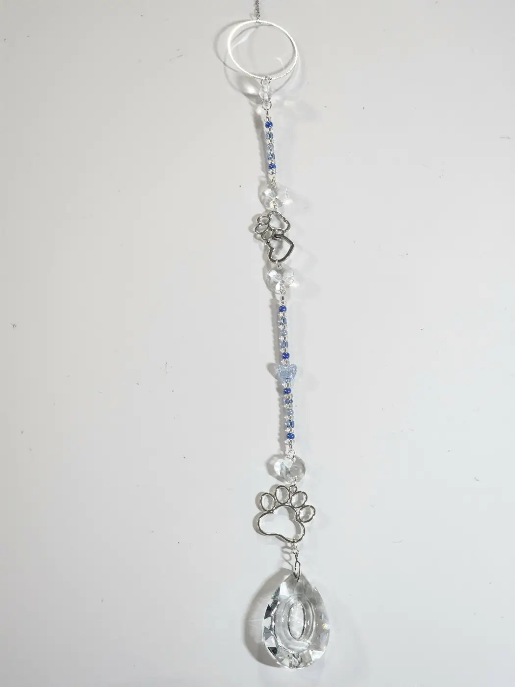 Delicate long suncatcher with silver tone, clear and blue crystals, paw print charms, perfect for direct sunlight display