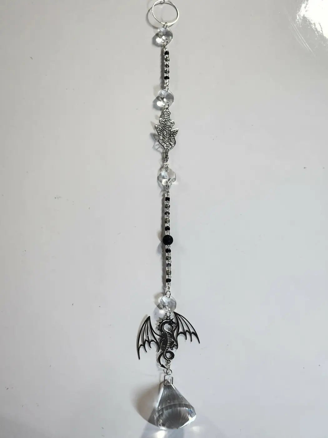 Long suncatcher silver dragon-themed with clear crystal beads and faceted teardrop pendant for direct sunlight display
