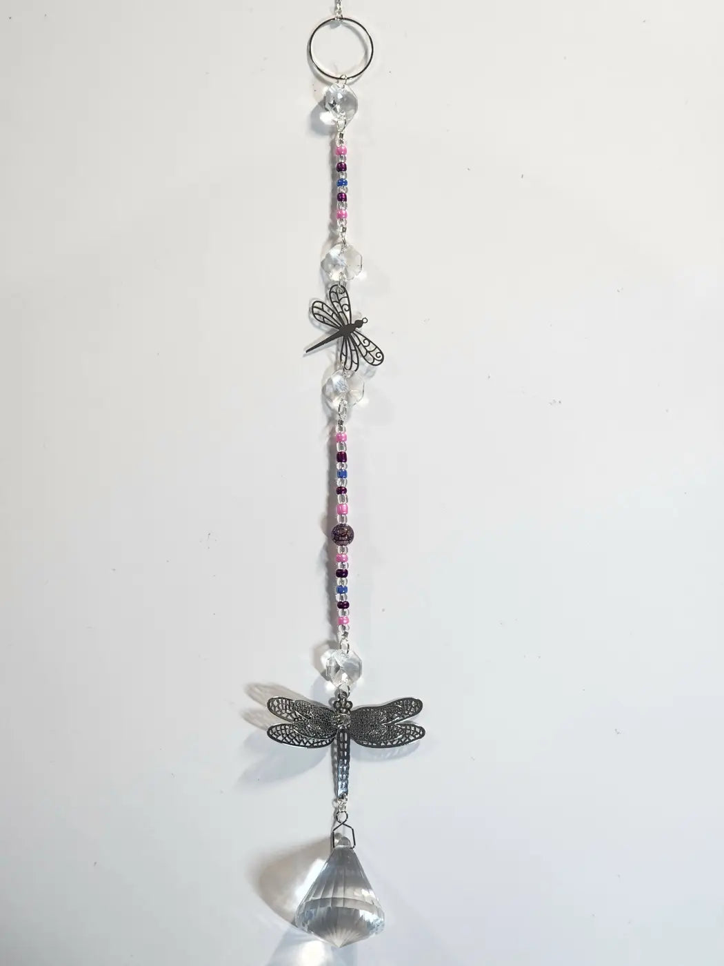 Long suncatcher dragonfly with black metal wings clear crystal beads and a faceted prism ideal for direct sunlight display