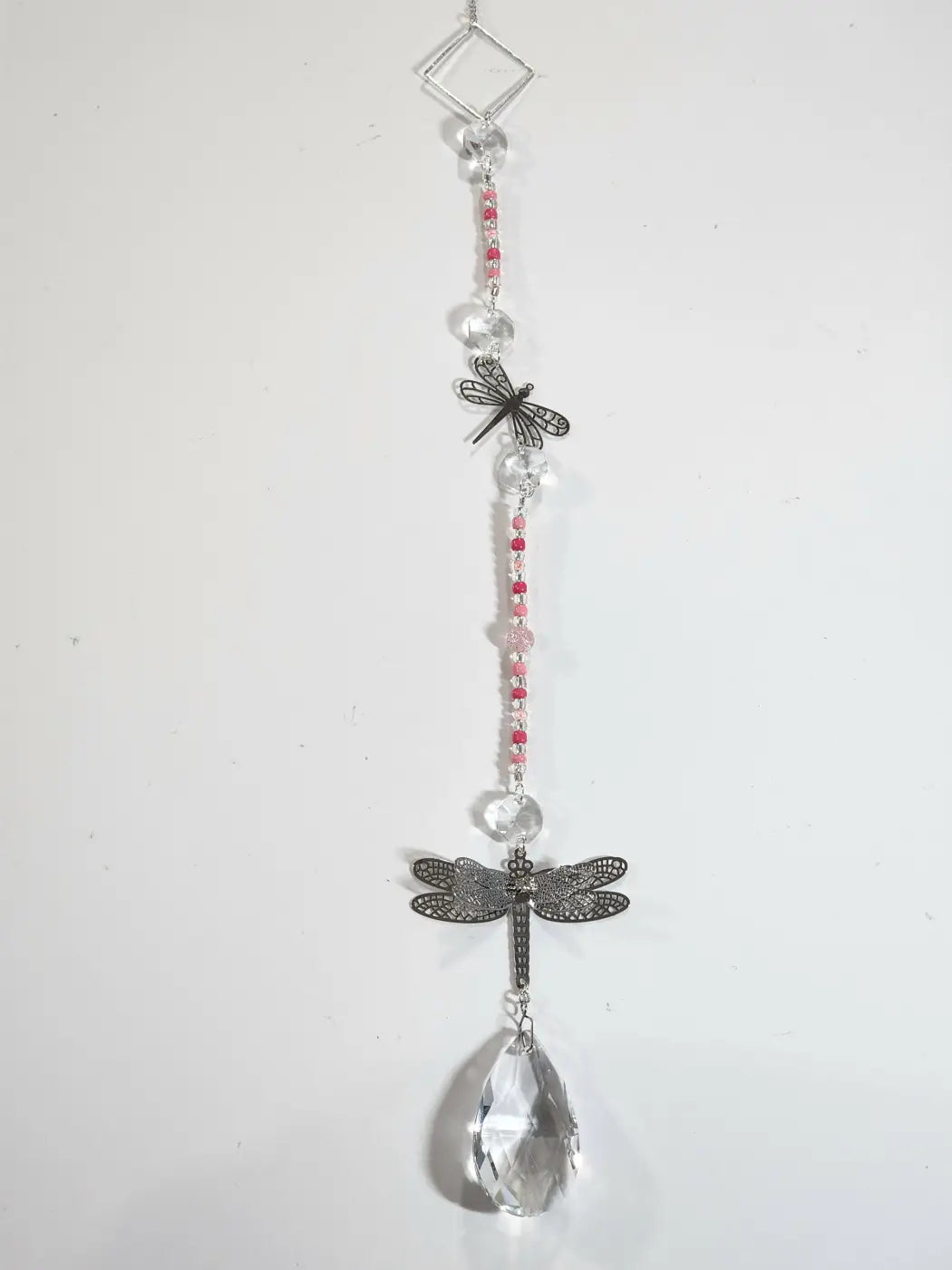 Long suncatcher with dragonfly design, clear and pink beads, silver metalwork, and crystal teardrop for direct sunlight