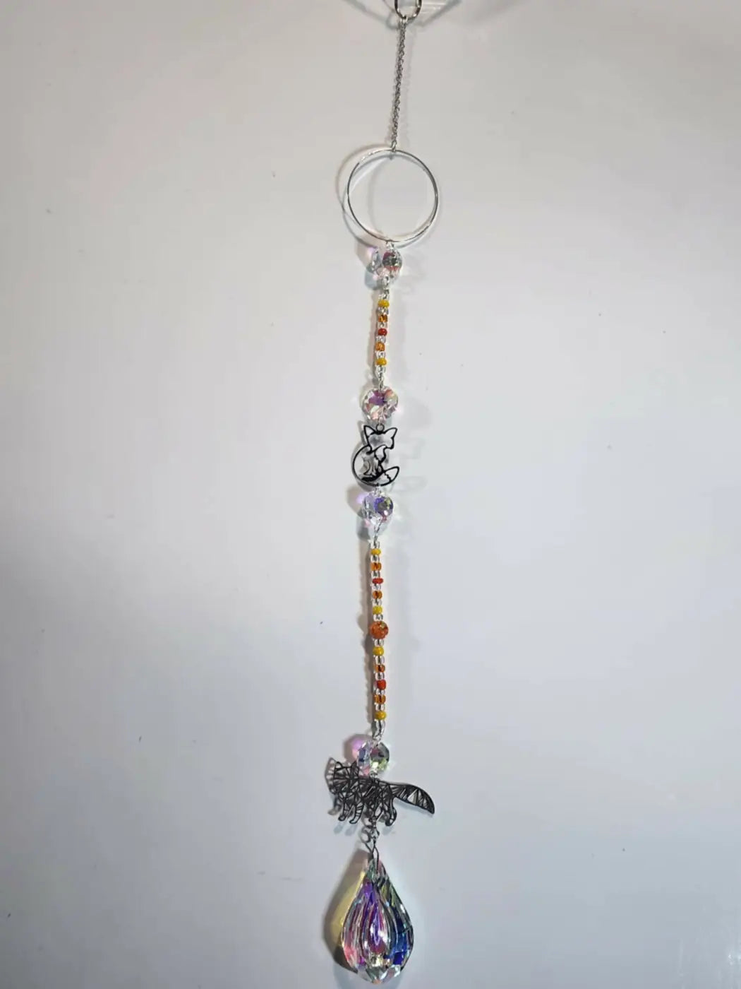 Long suncatcher with rainbow crystal, silver metal ring, fox and butterfly charms, ideal for direct sunlight display