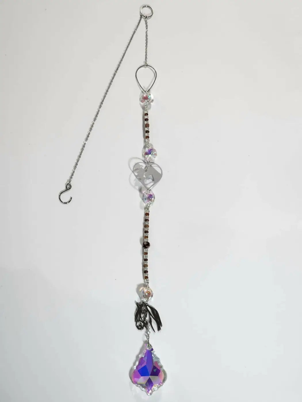 Long suncatcher with silver chain, clear and purple crystal beads, heart charms, and a teardrop prism for direct sunlight