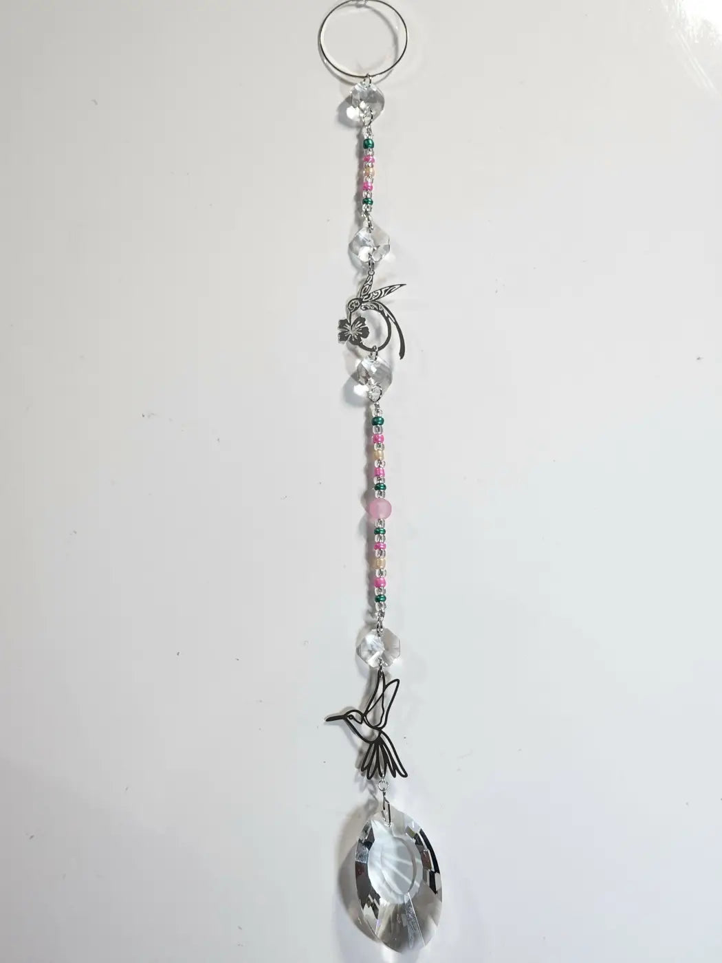 Long suncatcher with hummingbird silver wire charm, clear crystal beads, pink and green accents for direct sunlight use