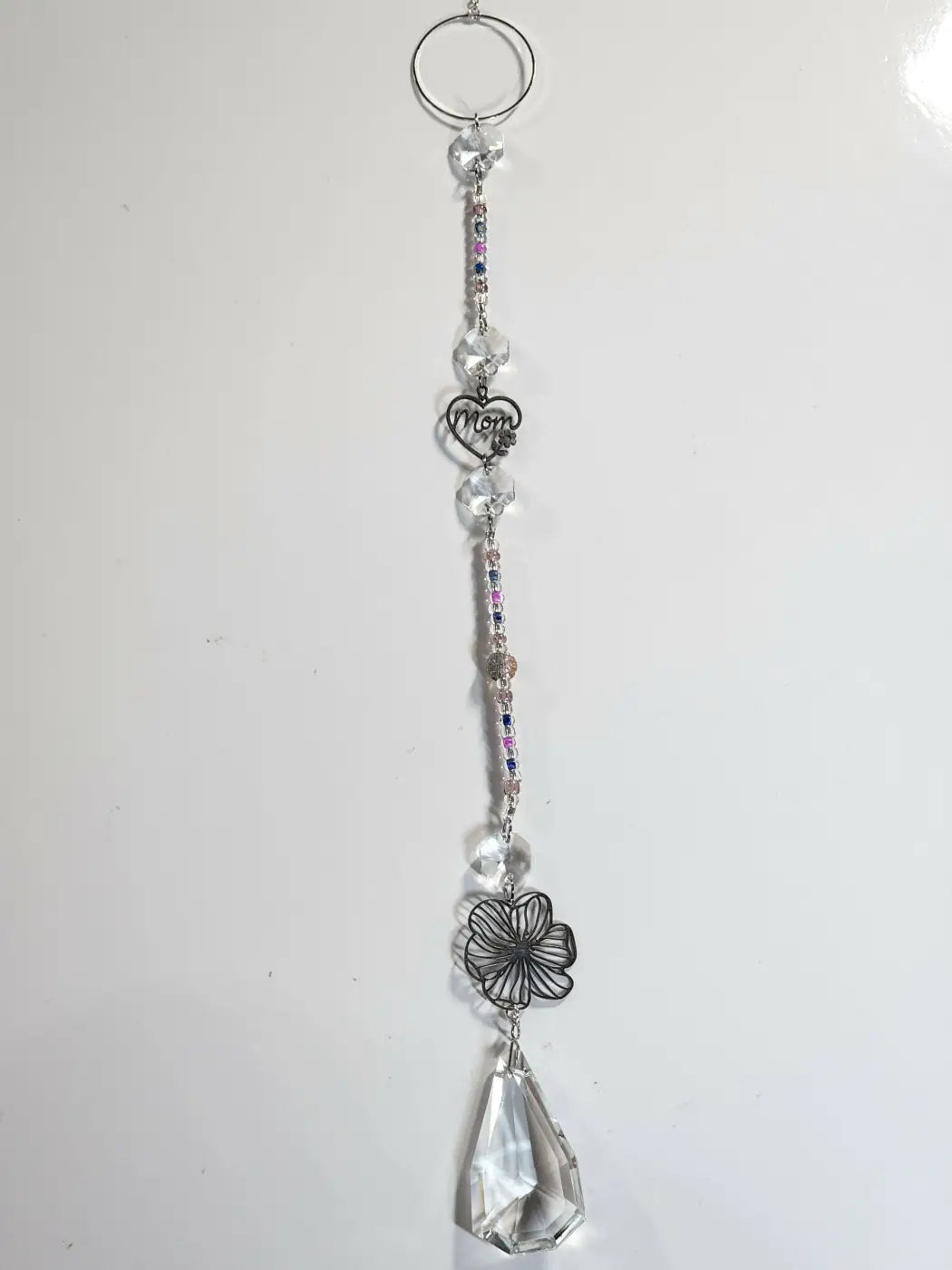 Long suncatcher with clear crystal, silver mom heart charm, and black wire flower design for direct sunlight display