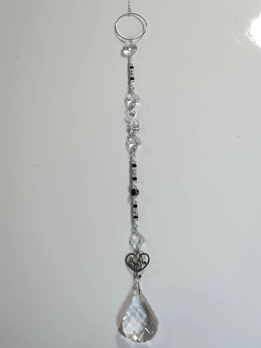 Long suncatcher with silver tones clear and black crystal beads and teardrop pendant ideal for direct sunlight and suction cup display