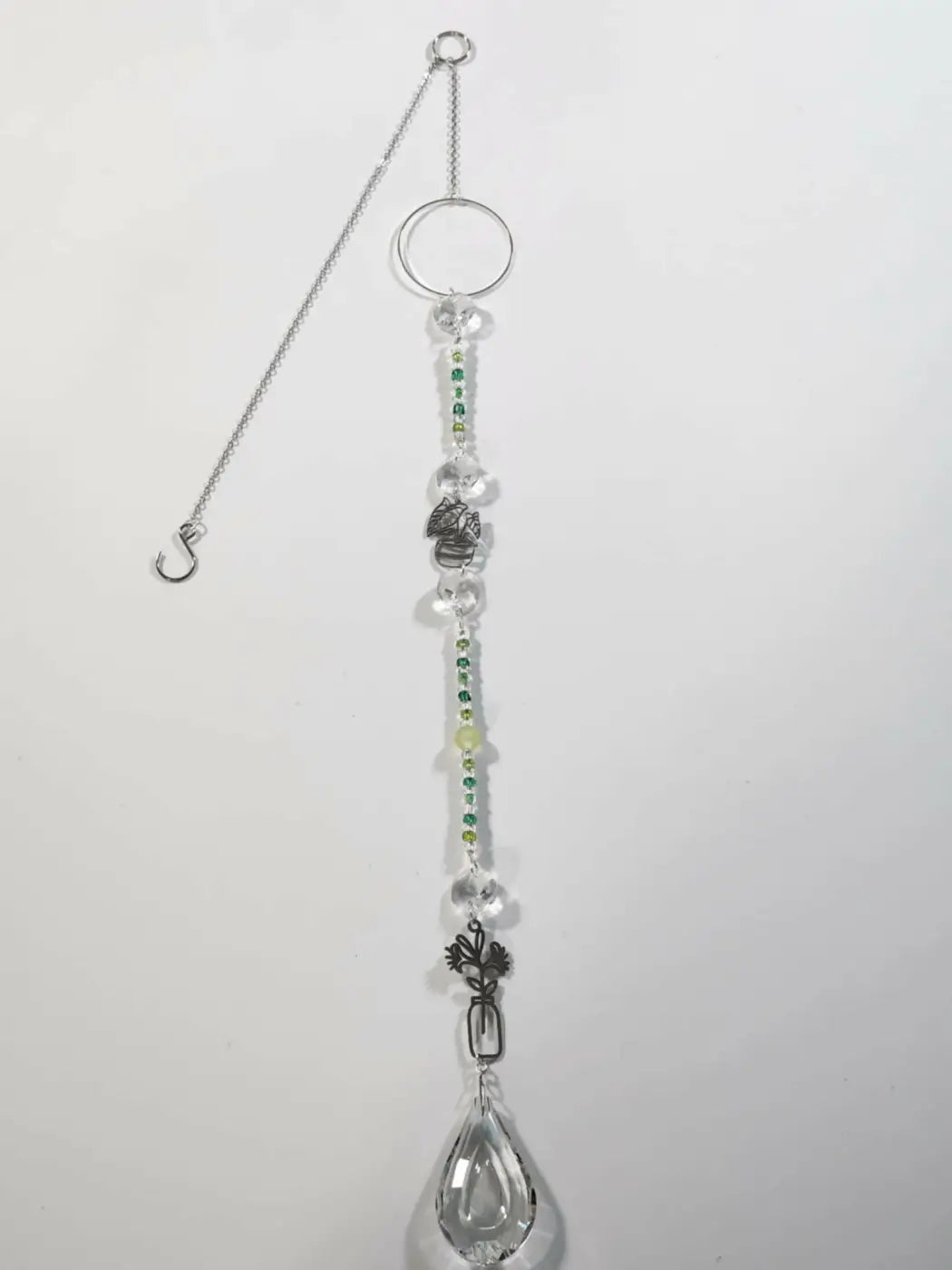 Long suncatcher with silver tones clear and green beads skull charm and teardrop crystal pendant for direct sunlight display