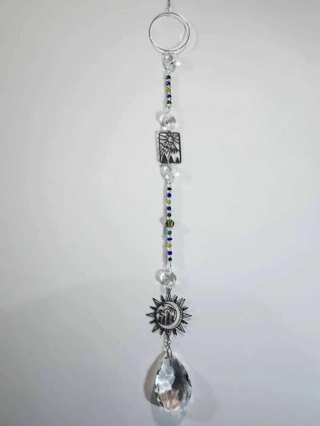 Long suncatcher with silver-toned sun and moon charms clear crystal beads and faceted teardrop pendant for direct sunlight