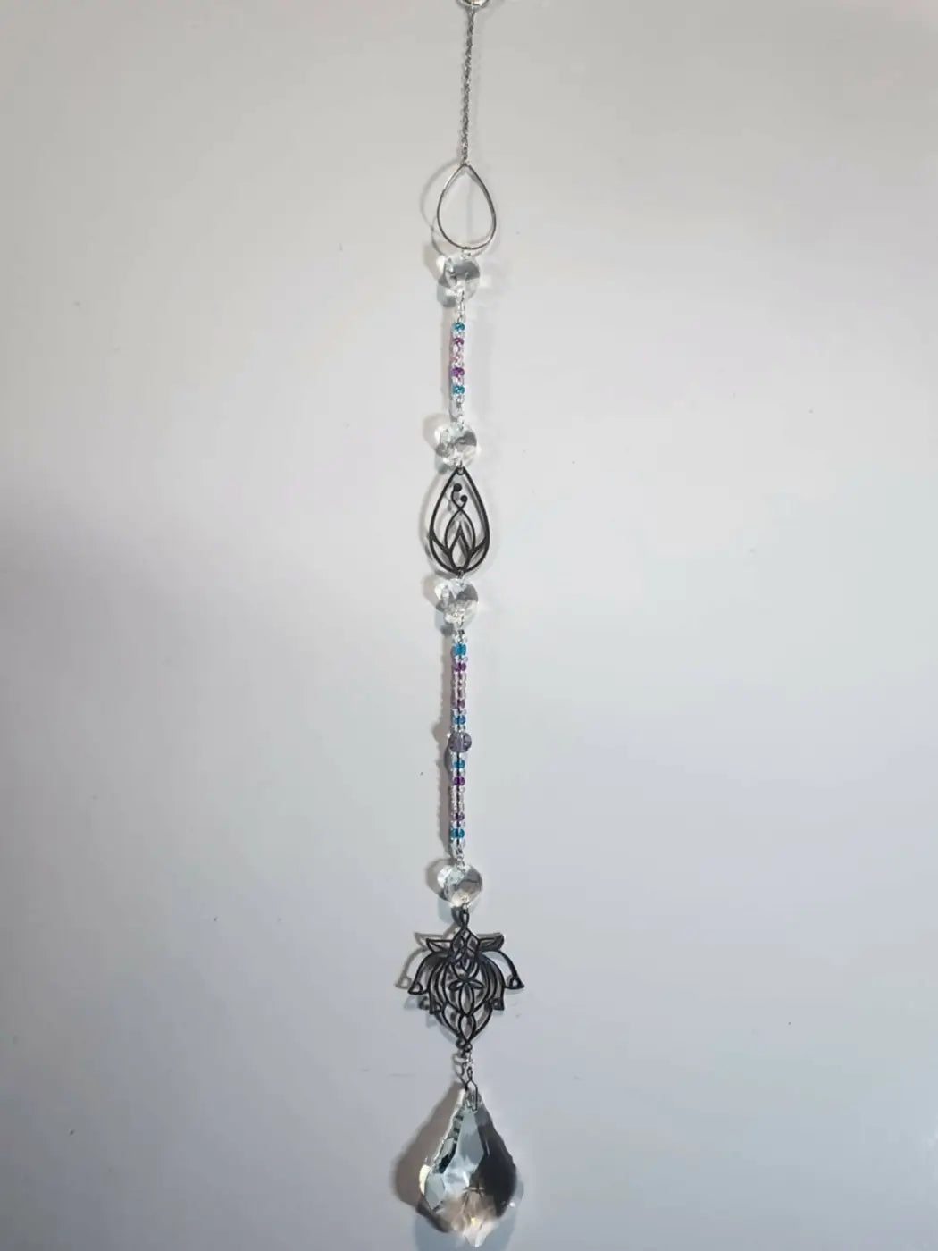 Long suncatcher silver-toned lotus design with clear crystal beads and teardrop prism ideal for direct sunlight display