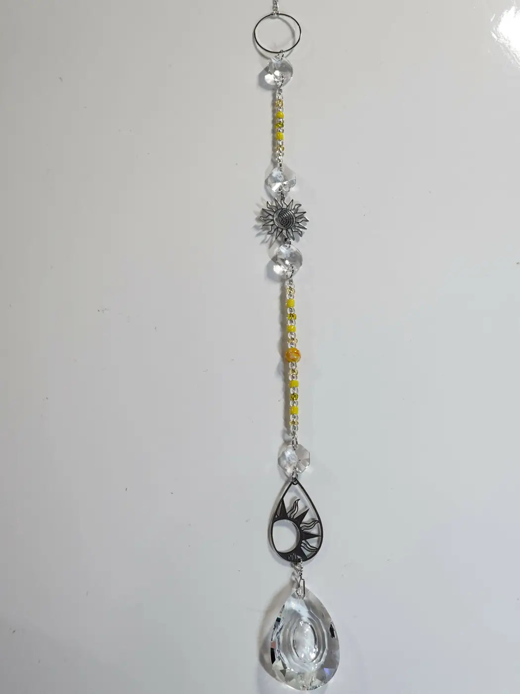 Long suncatcher with clear crystal beads silver sunflower charm and teardrop pendant ideal for direct sunlight display
