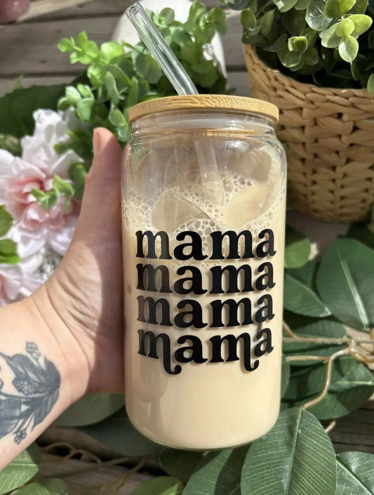 Clear mama glass cup with bamboo lid and black mama text filled with iced coffee and glass straw