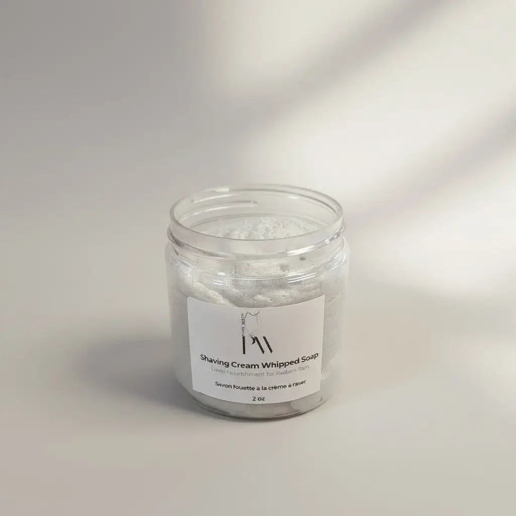 A clear glass jar of white men’s shaving cream whipped soap by rocky mountain soap marked 2 oz for shaving use