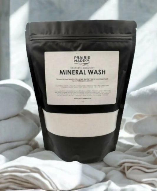 Black resealable pouch of prairie made co natural laundry powder featuring mineral wash for effective cleaning
