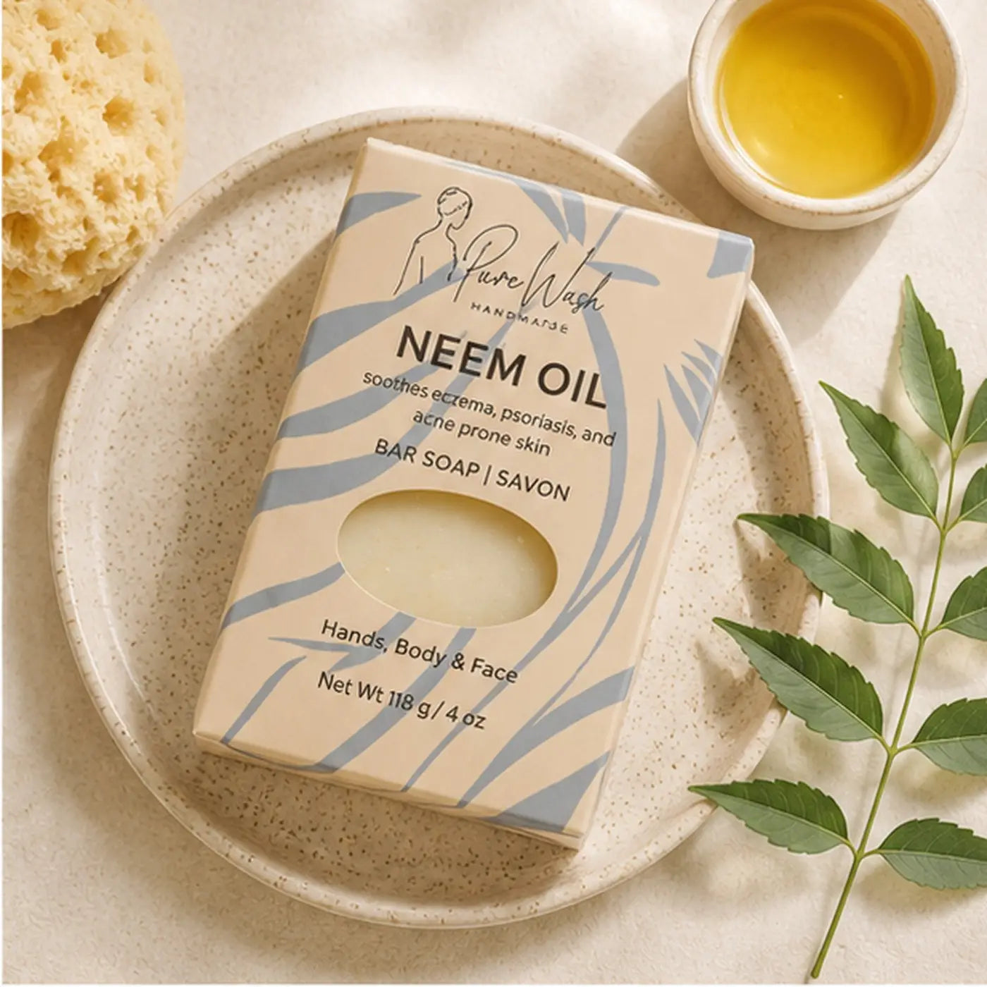 A beige and blue patterned box of neem oil soap bar with a clear window showing pale yellow soap for sensitive skin body bar use