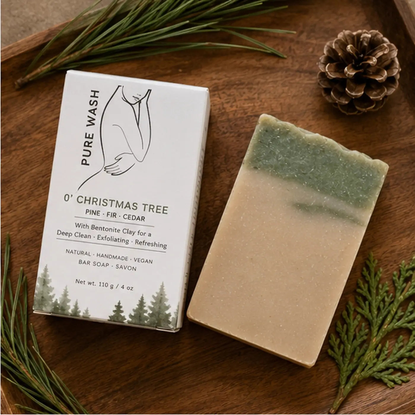 A rectangular christmas tree bar soap with beige to green gradient, bentonite clay exfoliant, and fresh pine christmas scent