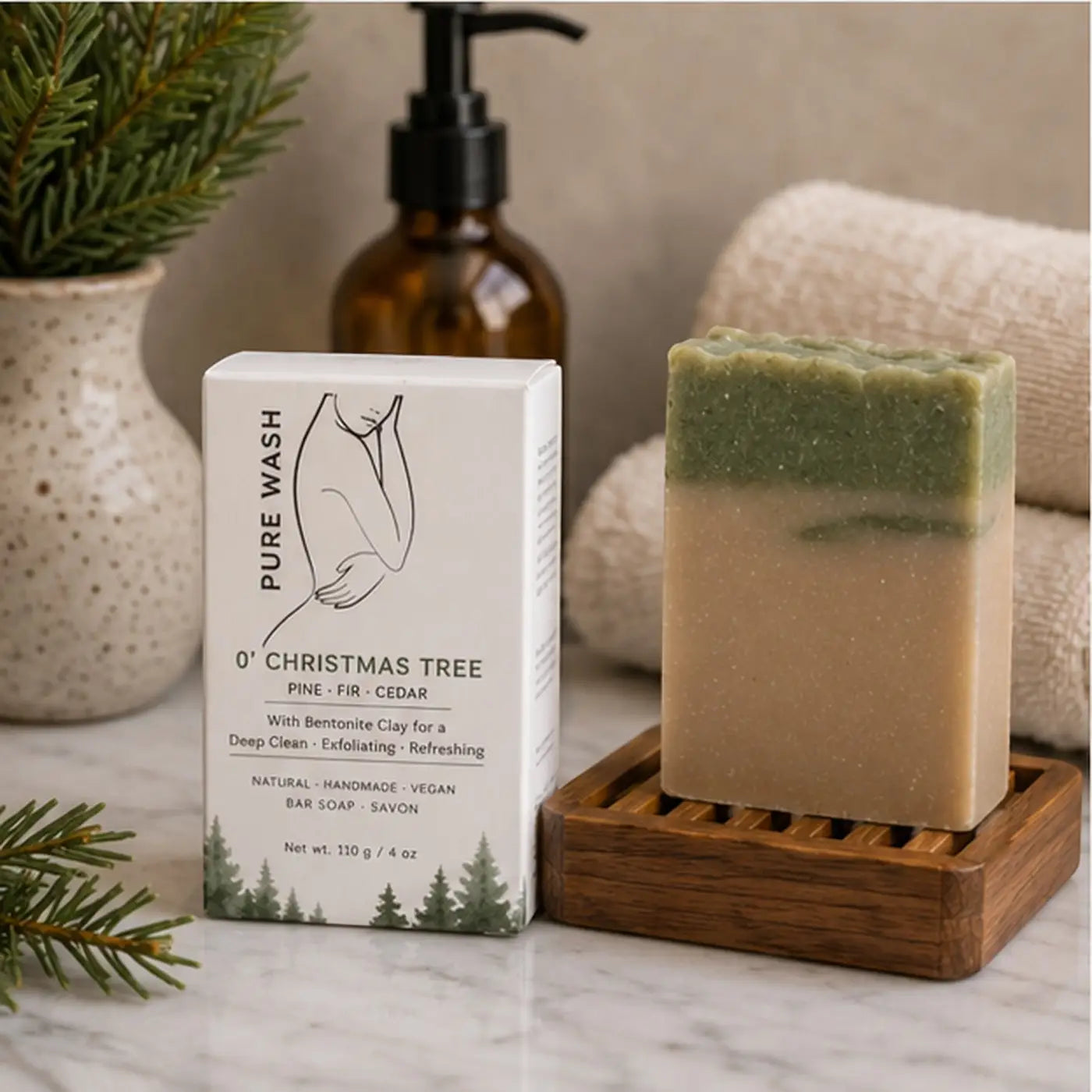 A two-toned rectangular christmas tree bar soap in green and beige with fresh pine christmas scent in pure wash packaging