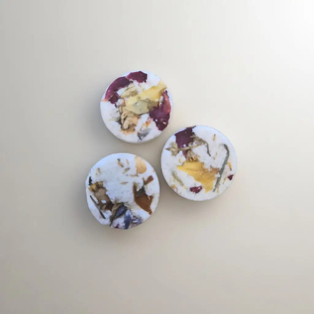 Three white pedi bombs with dried rose petals and botanicals handmade soap canada by pure wash