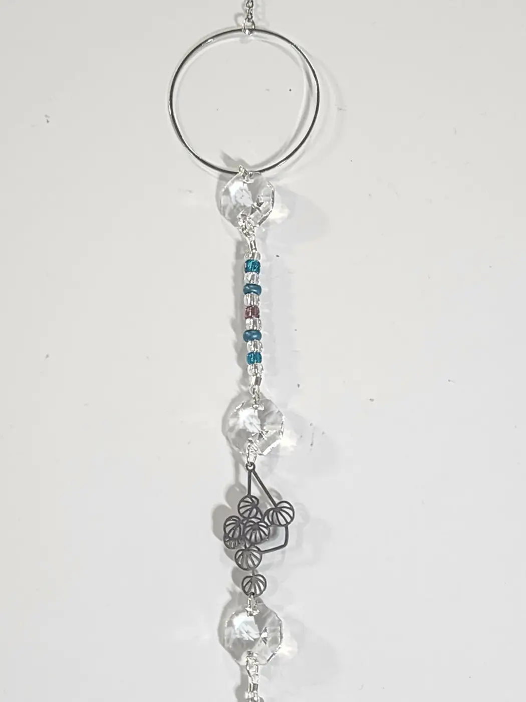 Plant long suncatcher with silver circular ring clear crystal and teal beads as an iridescent ornament and light catcher