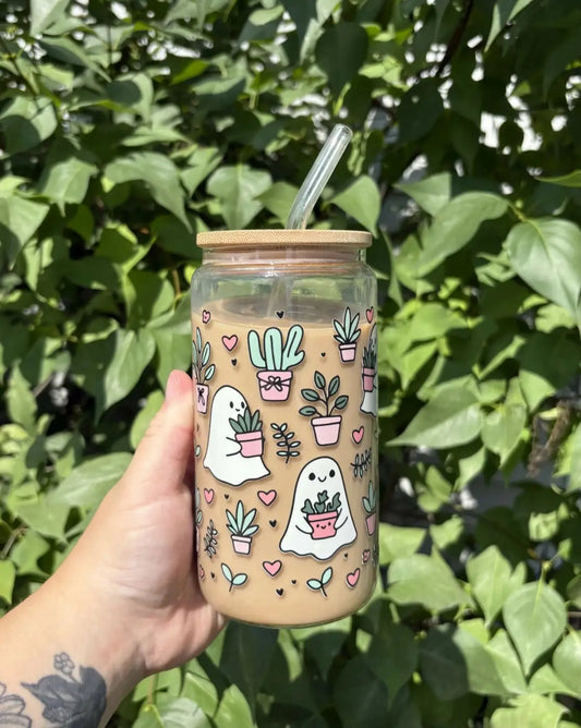 Clear glass ghosts cup with bamboo lid and glass straw featuring pink and green ghost and plant illustrations