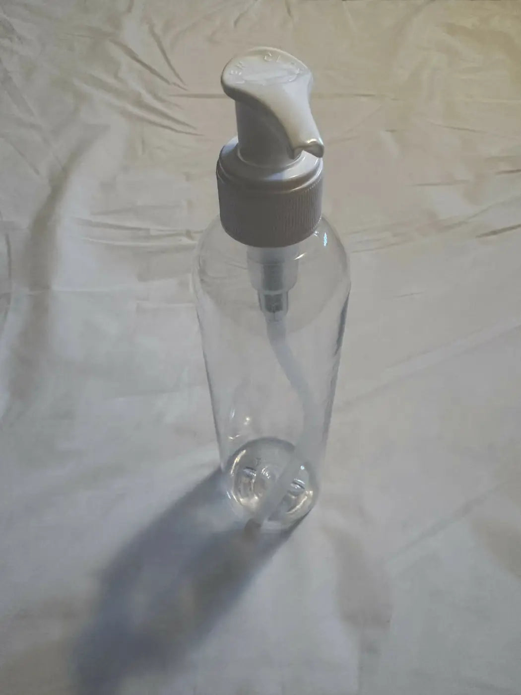 Clear plastic pump bottle with white dispenser ideal for canadian made skincare and natural skincare canada products