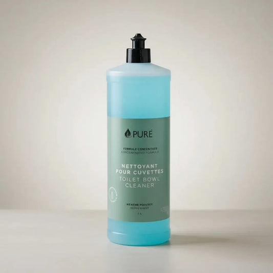 A translucent turquoise plastic bottle with black pump labeled pure toilet bowl cleaner in french and english for in-store refill