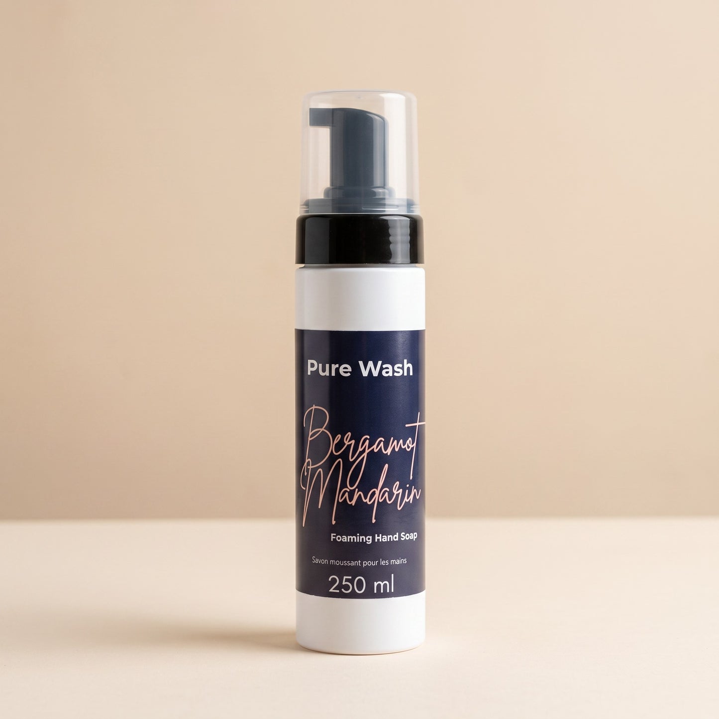 Pure Wash Bergamot Mandarin foaming hand soap in a white 250ml pump bottle against a neutral beige background.
