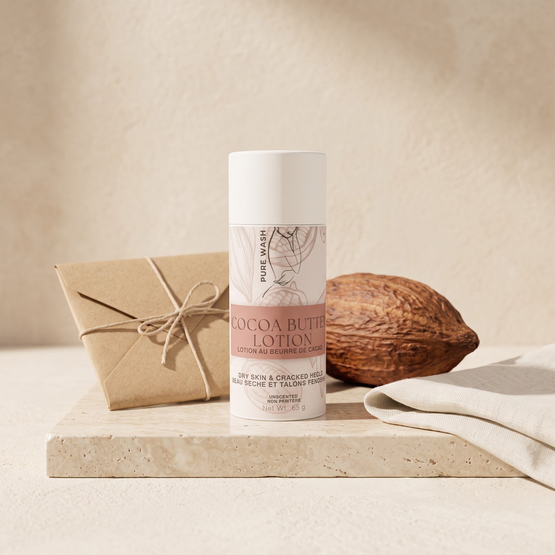 Pure Wash cocoa butter lotion stick for dry skin, featuring a minimalist tube on a stone base with a cacao pod.