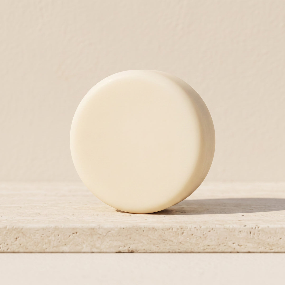 Pure Wash lavender chamomile solid conditioner bar with shea butter and oils on a textured stone surface