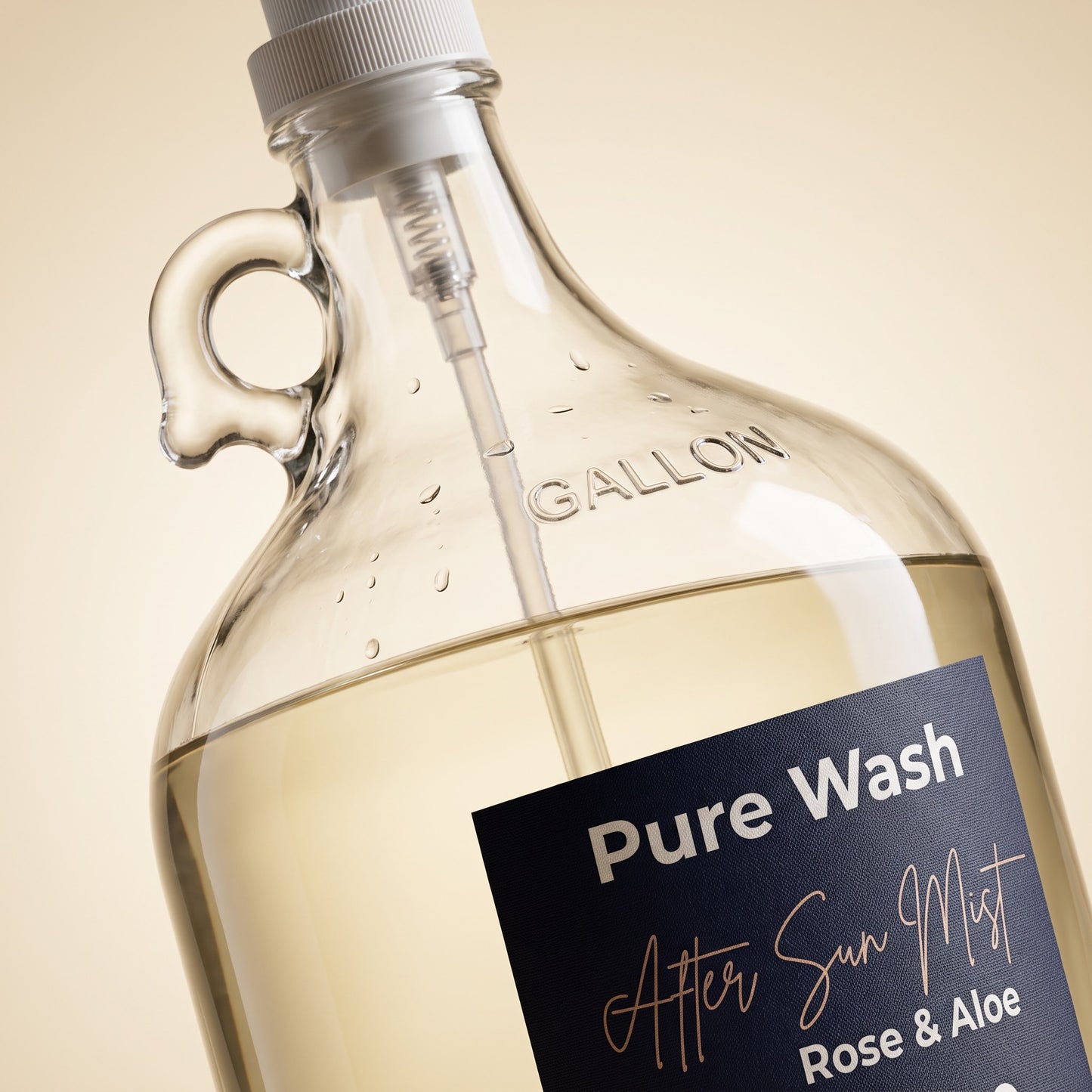 Pure Wash Rose & Aloe after-sun hydrating mist in a large glass refill gallon jug with a pump dispenser