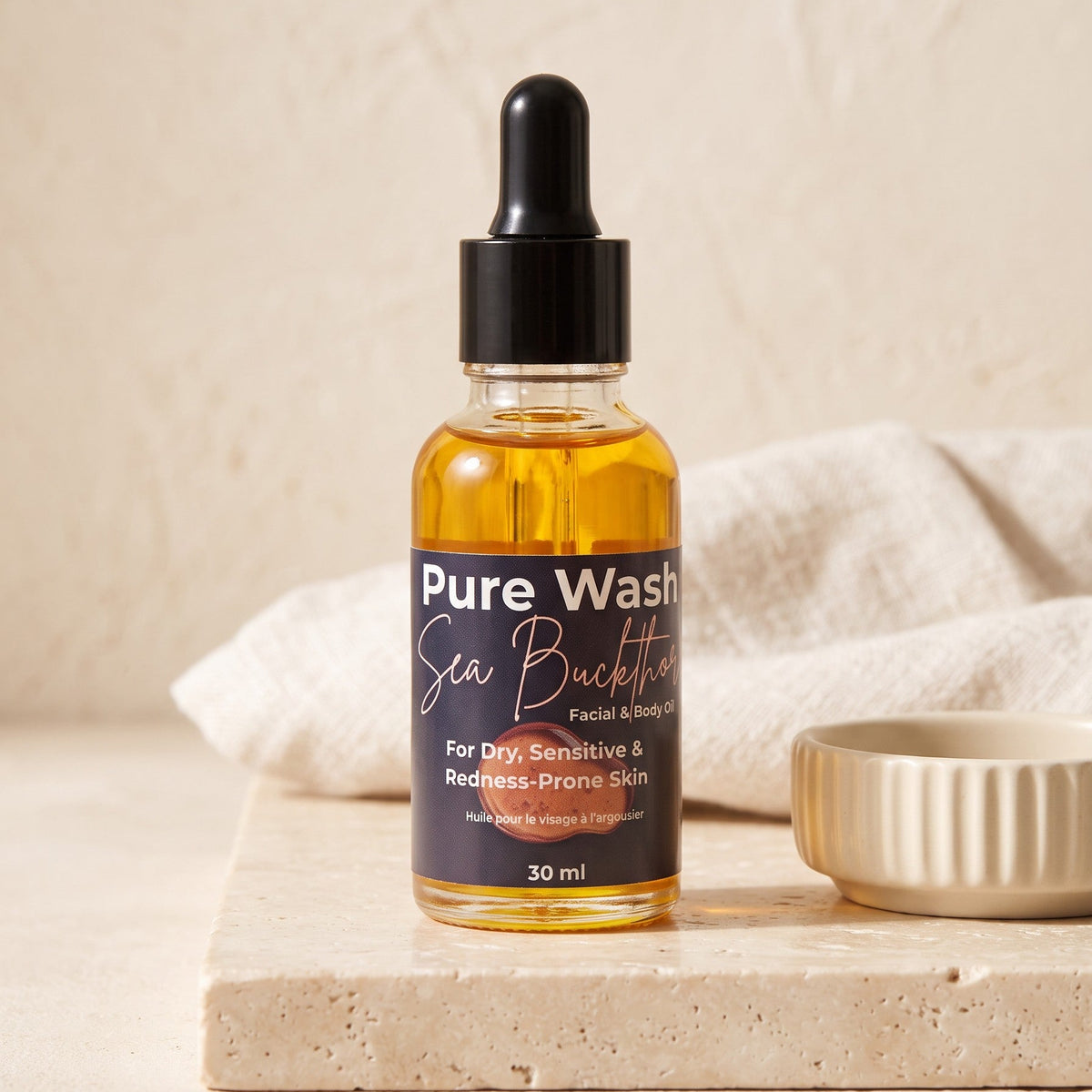 Pure Wash Sea Buckthorn facial oil in a glass dropper bottle for dry, sensitive, and redness-prone skin.