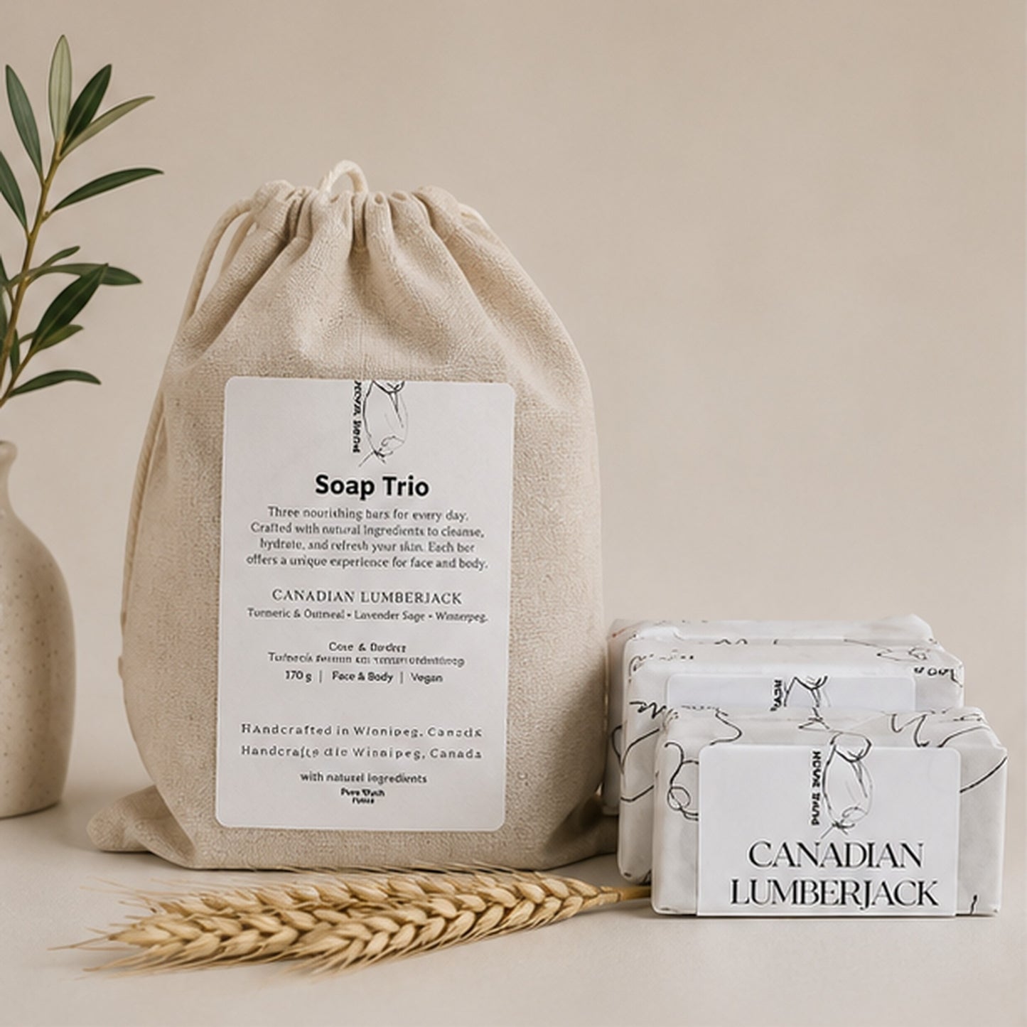 Pure Wash soap trio set with three botanical bars and a beige cotton canvas drawstring bag on a neutral surface.