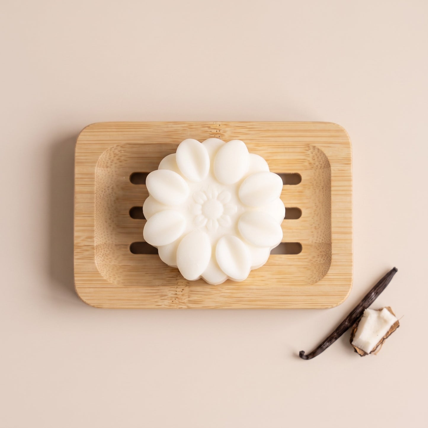 Pure Wash solid body lotion bar with shea butter and coconut oil on a wooden soap dish with vanilla and coconut