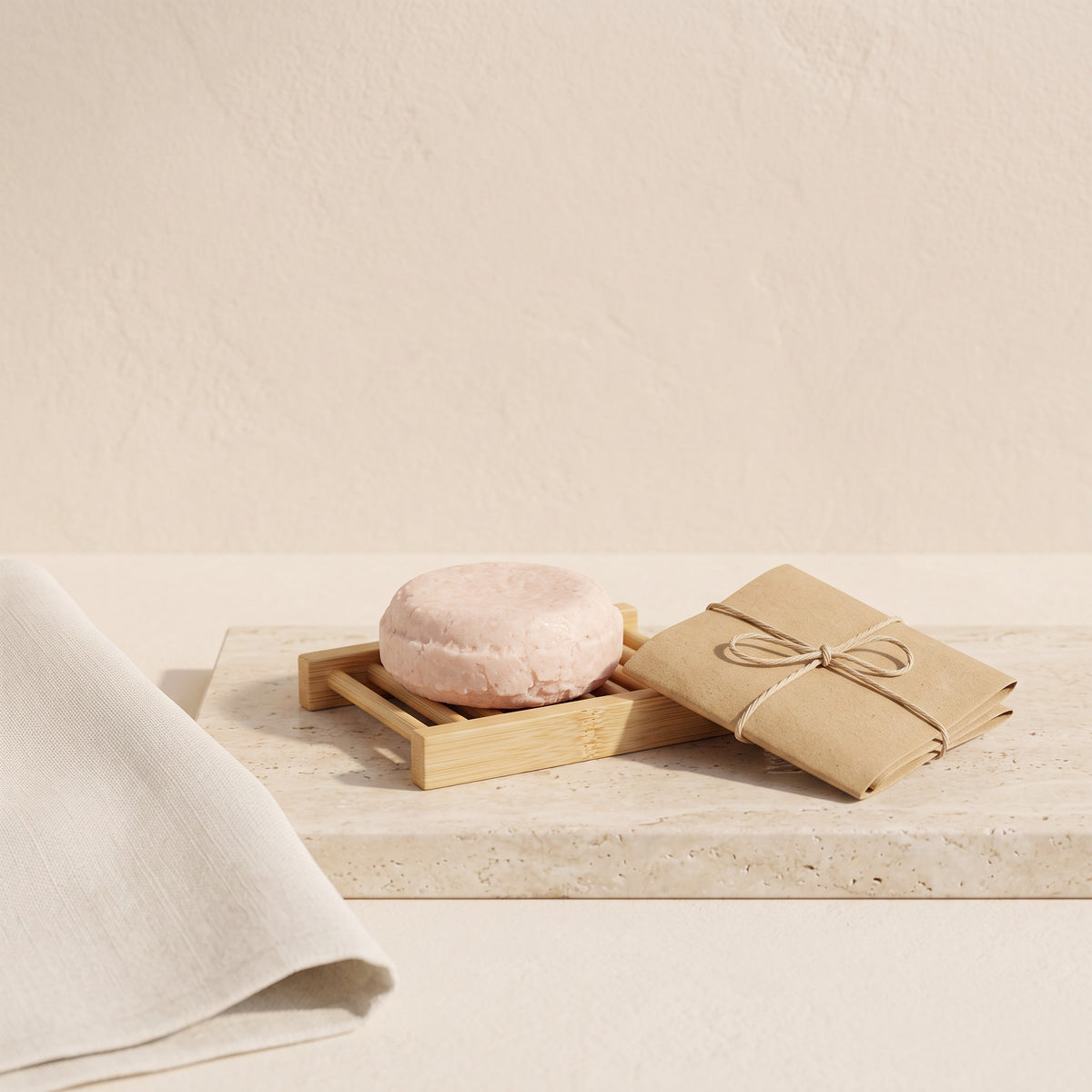 Pure Wash solid shampoo bar on a bamboo soap dish with eco-friendly paper packaging on a stone surface.