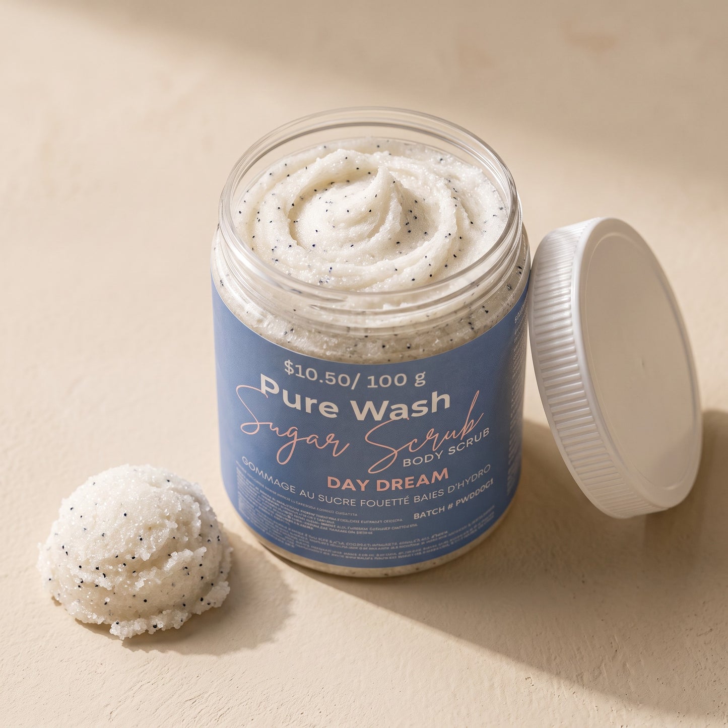 Pure Wash Day Dream sugar body scrub in a clear jar with a white lid, featuring a textured white exfoliating paste.