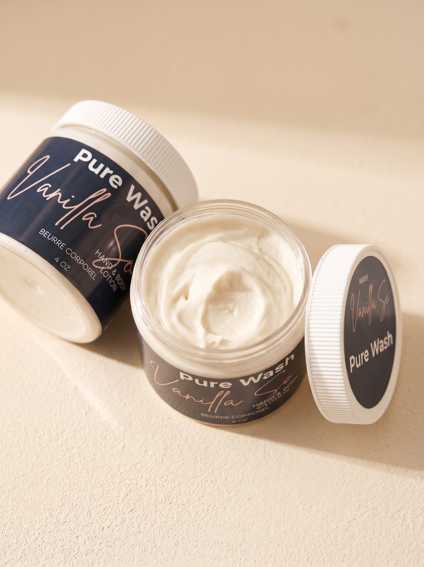 Pure Wash vanilla hand and body lotion in a jar with a creamy texture, featuring shea butter and nourishing oils.