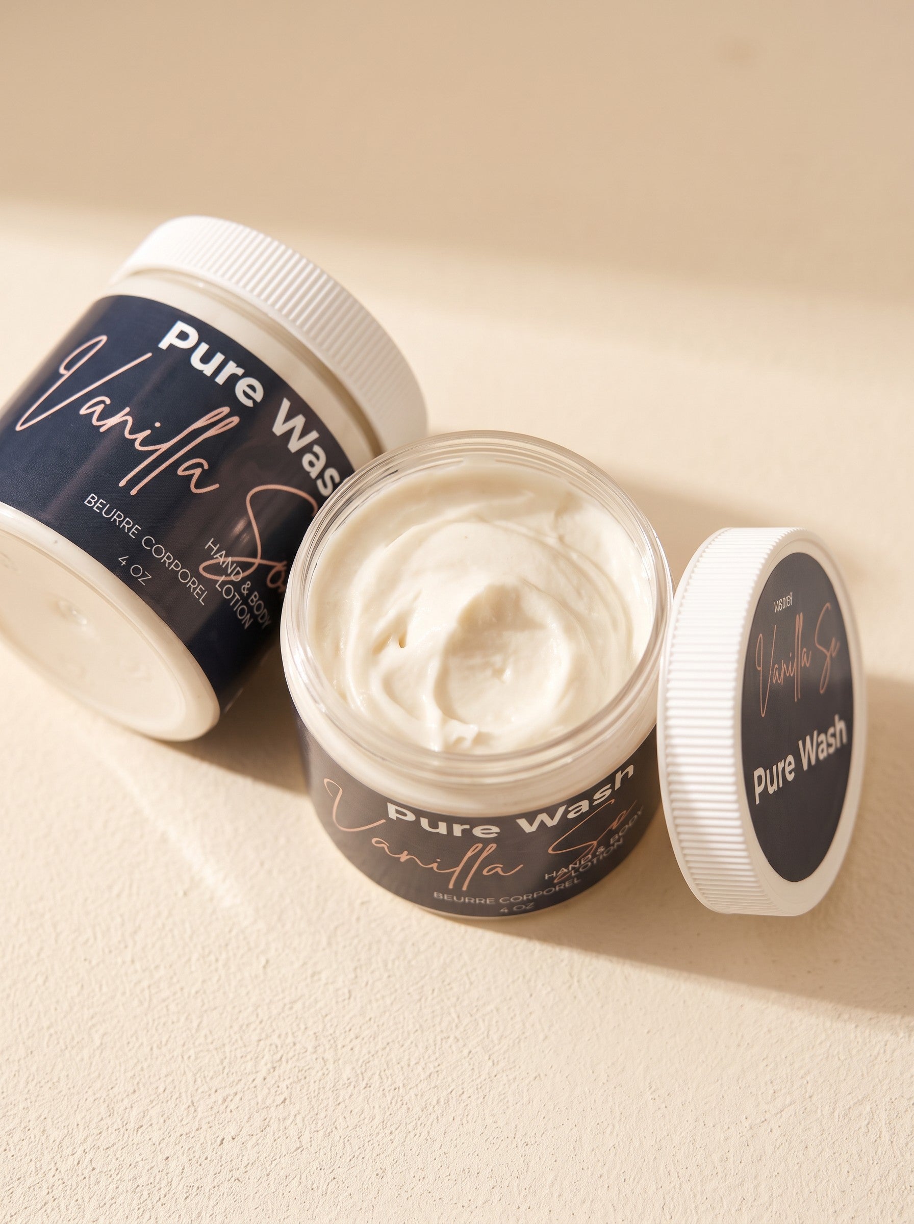 Pure Wash vanilla hand and body lotion in a jar with a creamy texture, featuring shea butter and nourishing oils.