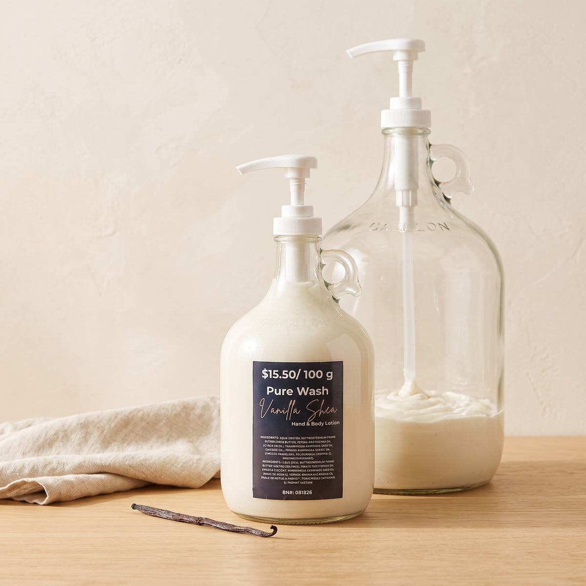 Pure Wash vanilla shea body lotion in a glass refill bottle with a pump dispenser on a wooden surface.