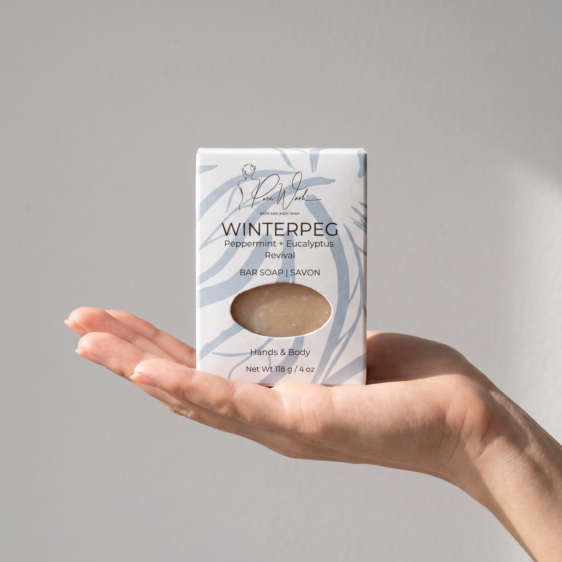 Pure Wash WinterPeg peppermint and eucalyptus scented soap bar held in a hand against a neutral background.
