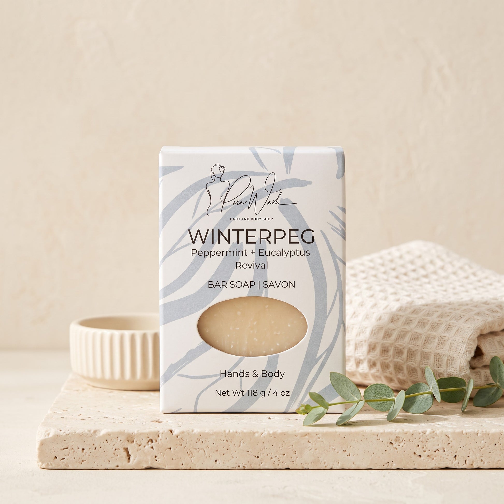 Pure Wash WinterPeg soap bar with peppermint and eucalyptus scent in decorative packaging on a stone tray.