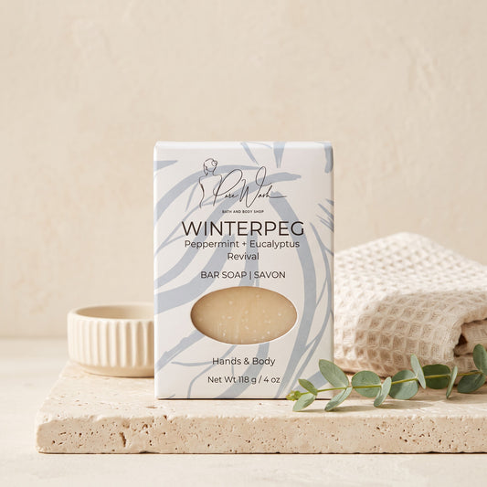 Pure Wash WinterPeg soap bar with peppermint and eucalyptus scent in decorative packaging on a stone tray.
