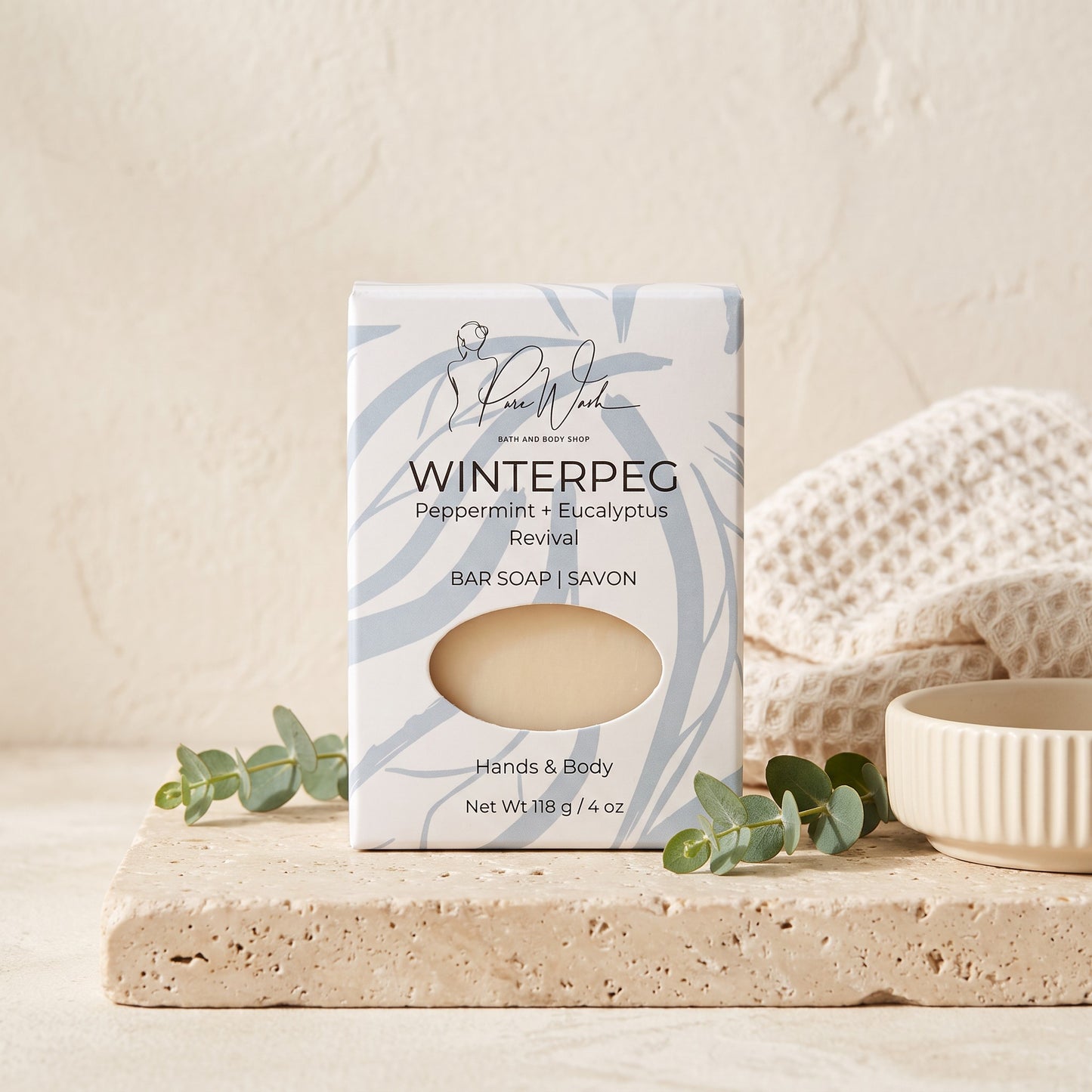 Pure Wash WinterPeg peppermint and eucalyptus scented soap bar in decorative packaging on a stone surface.