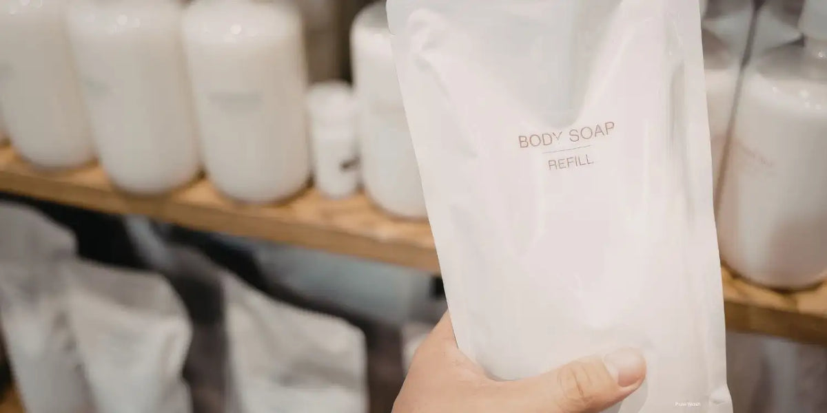A translucent white refill pouch for body soap, labeled with minimalist black text