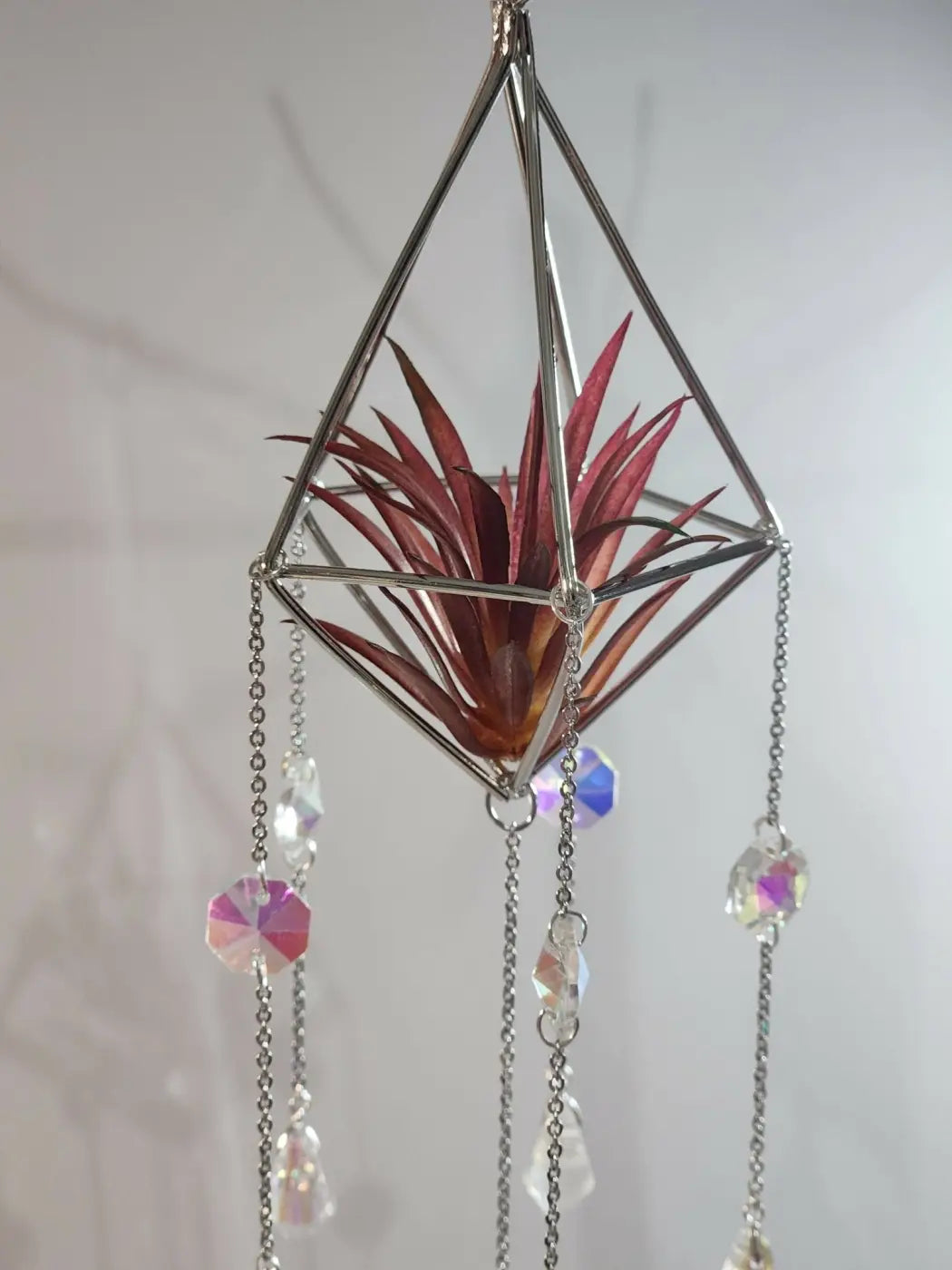 Geometric silver metal pyramid air plant suncatcher with red air plant and iridescent crystal bead ornament hanging