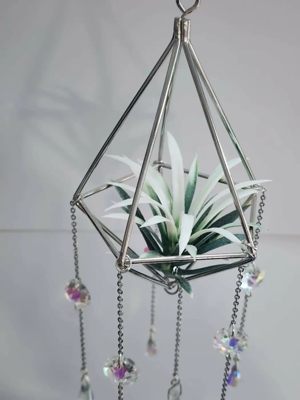 Silver geometric pyramid air hanging planter with white air plant and iridescent crystal beads air plant suncatcher