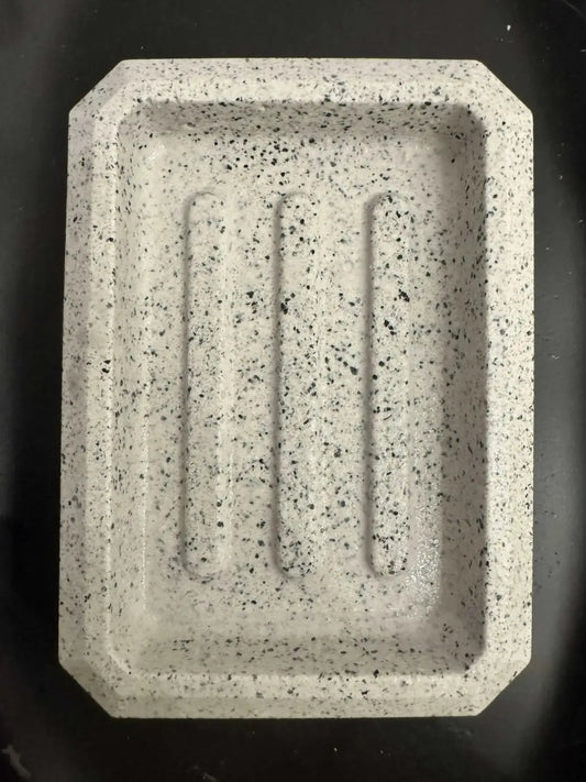 Rectangle soap dish in speckled gray stone with three raised grooves ideal for pure wash and penetrating sealer use