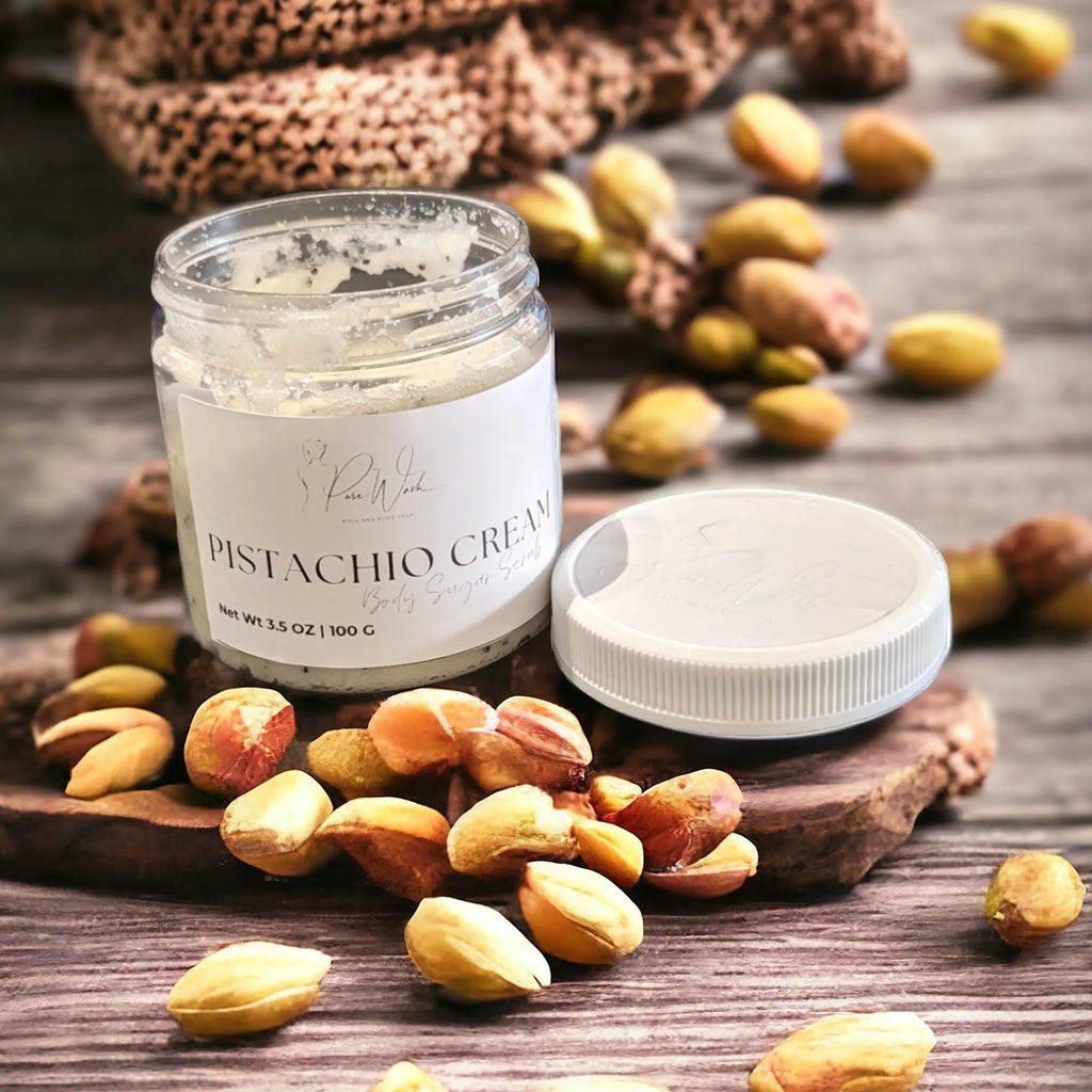 Pure Wash Whipped Body Sugar Scrub in Pistachio Cream scent with pistachios on rustic background.