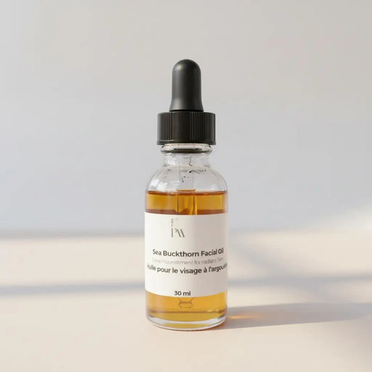 A clear glass bottle with black dropper cap contains amber sea buckthorn facial massage oil labeled 30 ml for skin benefits