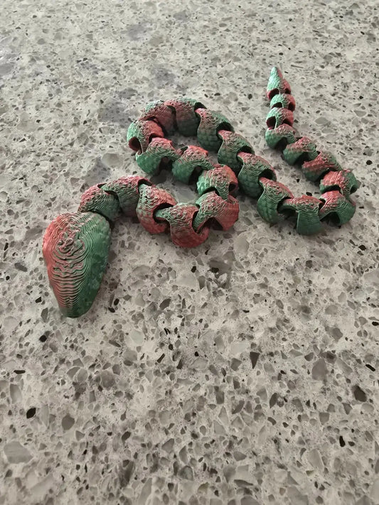Segmented bendable short snake toy with textured green and red body, ideal for pure wash and handmade soap Canada gifts