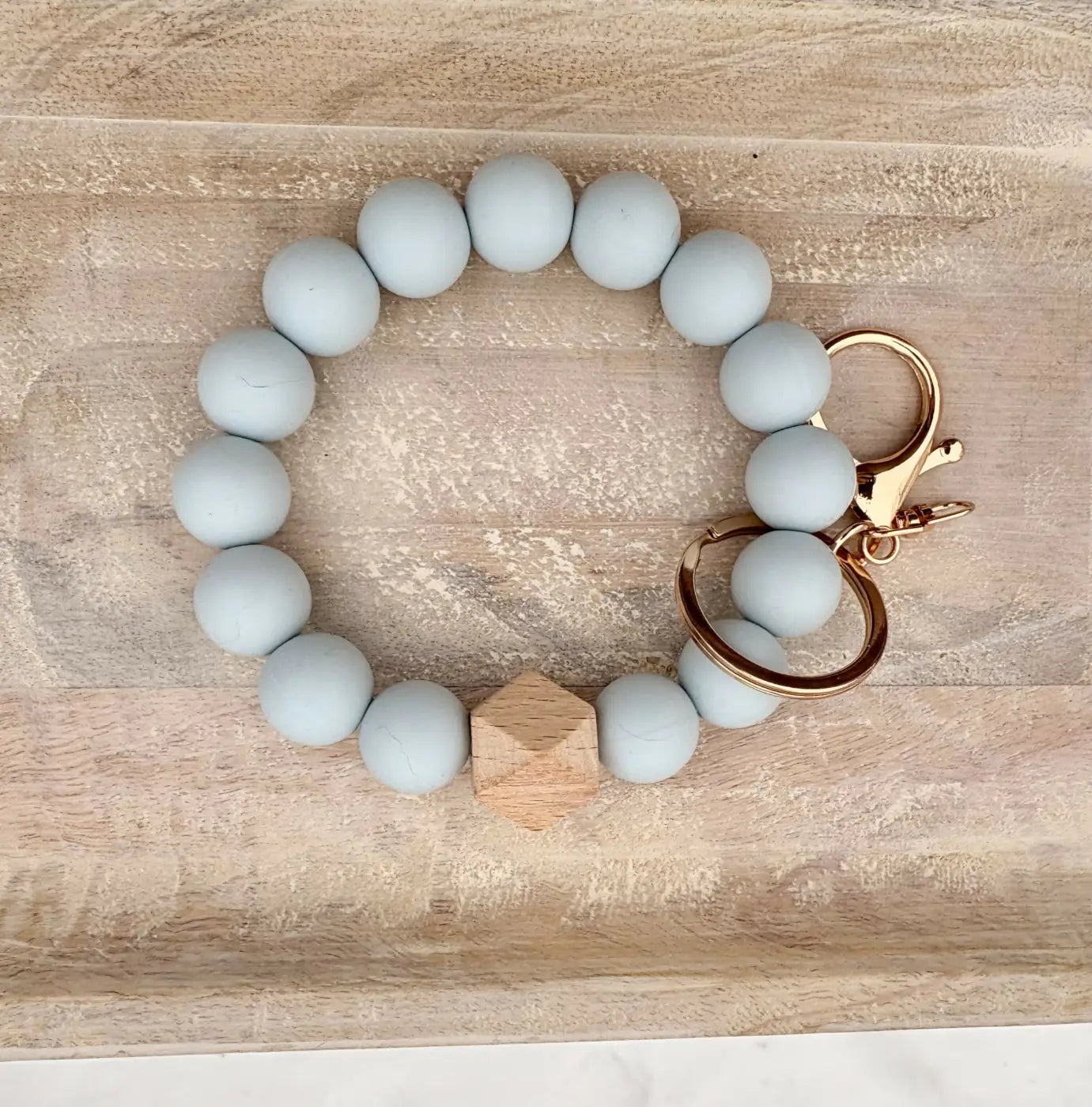 Single colour silicone bead wristlet in light blue matte silicone with gold clasp and wooden hexagon charm beaded wristlets
